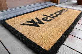 A Brown Mat With Black Color Welcome