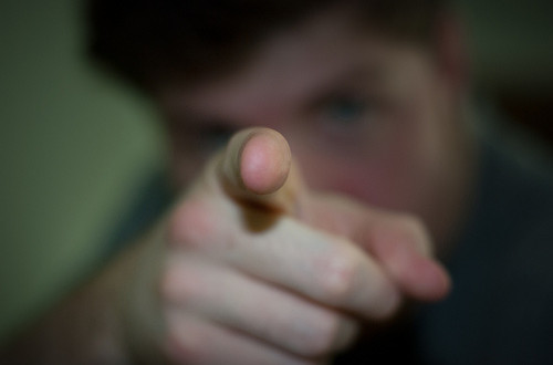 A picture of a man pointing the finger at the camera