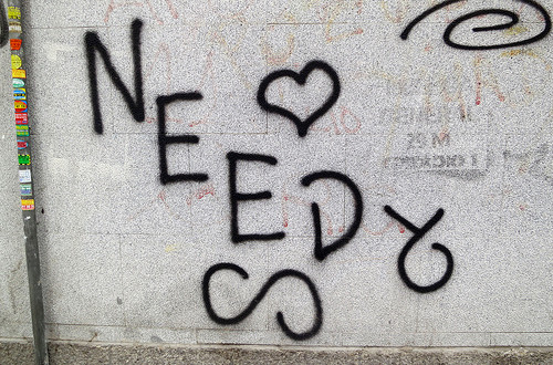 A graffiti with the word Need on the wall