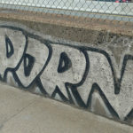 A graffiti of the word porn on a wall