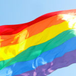 A picture of a rainbow flag waving